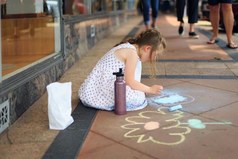 Child playing with sidewalk Chalk
